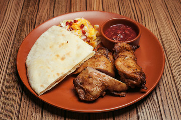 chicken skewers with salad and sauce on a background of wood. BBQ chicken. Healthy food. Healthy food. Flat lay. Top view