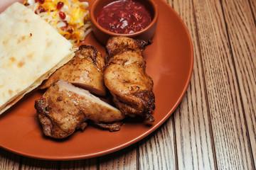 chicken skewers with salad and sauce on a background of wood. BBQ chicken. Healthy food. Healthy food. Flat lay. Top view