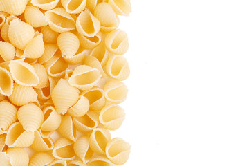A variety of types and forms of Italian pasta. Dry pasta in the shape of shells. Pile of shells pasta isolated on white background. There is some free space for your text or sign.