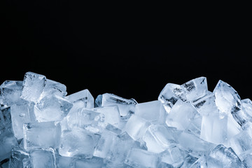 Obraz premium Ice cubes on black background, closeup view