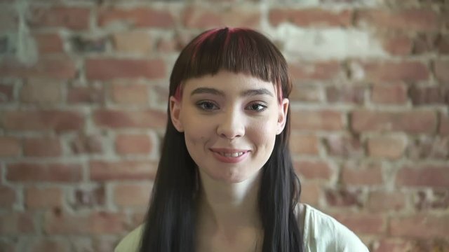 portrait of a young attractive young woman with hipster hairstyle. spbd. modern appearance of woman. positive pretty smiling female. style, caucasian, ager concept. people beauty