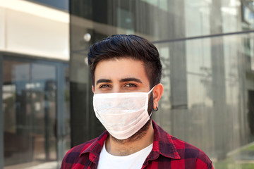 Young man wearing medical face mask,  portrait. Man wearing surgical mask for corona virus