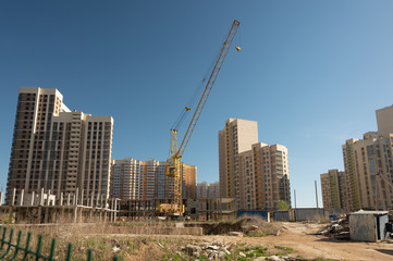 Fototapeta na wymiar Abandoned building site with column crane. Crisis in building sector in Russia