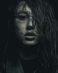 monochrome fashion portrait of a young girl, with drawings on her face