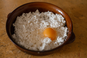 home-made cottage cheese and egg for making home-made cheesecakes in clay dishes