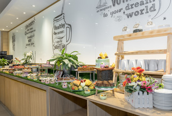 Large assortment of desserts, muffins, cakes, tarts. Candy bar wedding reception brunch buffet