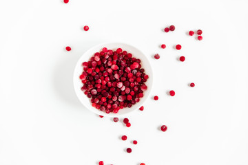 Frozen cranberries in the white plate.Fresh red berry cranberries.White background.Top view.
