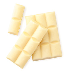 Pieces of white chocolate on a white background isolated. The view from top