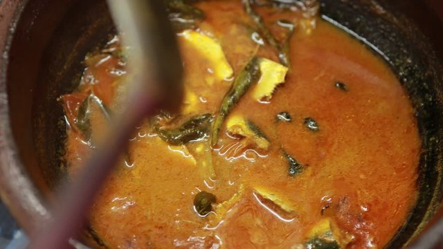 Meen Vattichathu or Pattichathu, sardine fish cooked. Traditional hot and spicy fish curry Kerala India with dried red chilly and green curry leafs. Very popular coastal food eat with tapioca or rice