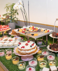 Large assortment of desserts, muffins, cakes, tarts. Candy bar during wedding reception or brunch