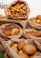 Selection of Fresh baked bread baskets and paper bags with bread roasted in the oven, croissants
