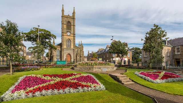 floral display in public gardens with a church as a backdrop