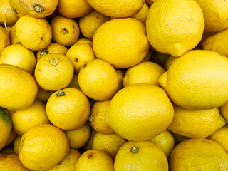 lots of ripe citrus yellow lemons to eat like a background