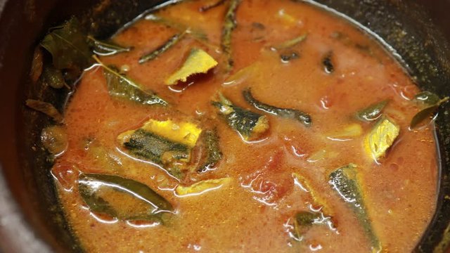 Meen Vattichathu or Pattichathu, sardine fish cooked. Traditional hot and spicy fish curry Kerala India with dried red chilly and green curry leafs. Very popular coastal food eat with tapioca or rice