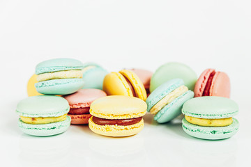 Sweet almond colorful pastel pink blue yellow green macaron or macaroon dessert cake isolated on white background. French sweet cookie. Minimal food bakery concept Copy space