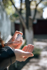 human hands using an antibacterial spray to disinfect against viral bacteria