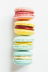 Sweet almond colorful pastel pink blue yellow green macaron or macaroon dessert cake isolated on white background. French sweet cookie. Minimal food bakery concept. Flat lay top view, copy space