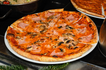 Delicious homemade Italian pizza served during brunch buffet