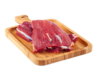 Raw meat on wooden board isolated on white background