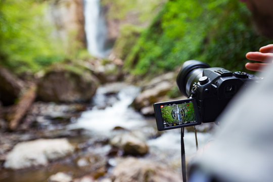 Photographer make video of waterfall deep in forest