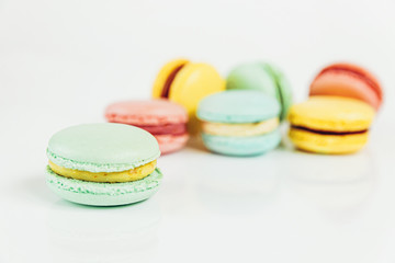 Sweet almond colorful pastel pink blue yellow green macaron or macaroon dessert cake isolated on white background. French sweet cookie. Minimal food bakery concept Copy space