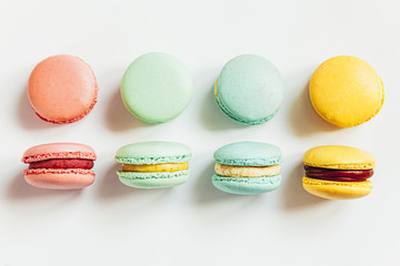 Sweet almond colorful pastel pink blue yellow green macaron or macaroon dessert cake isolated on white background. French sweet cookie. Minimal food bakery concept. Flat lay top view, copy space