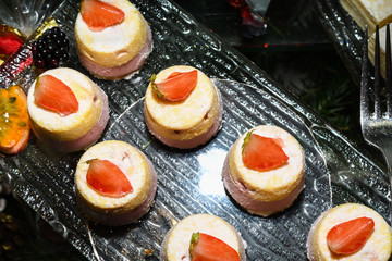 Various desserts in candy bar food buffet during hotel brunch, catering, cake pops, mousse, tarts