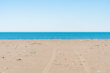 Dirty sandy beach of the Black Sea. Environmental pollution