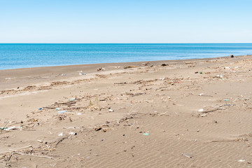 Dirty sandy beach of the Black Sea. Environmental pollution