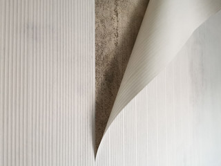 White paper wallpapers peel off from the wall.