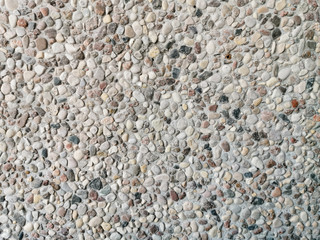 The texture of the wall of small stones.