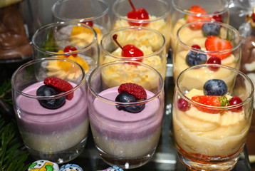 Various desserts in candy bar food buffet during hotel brunch, catering, cake pops, mousse, tarts