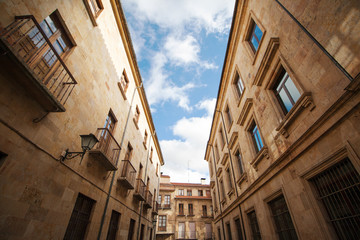 Fototapeta na wymiar A street in the historic quarter of Salamanca (Spain), an imponent example of the sanstone architecture 