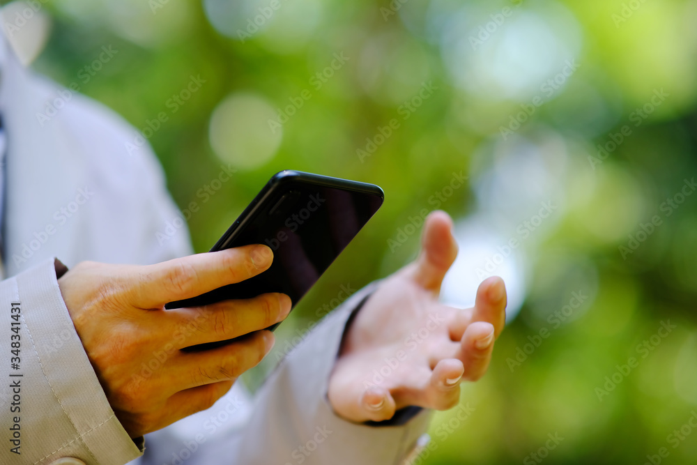 Poster close up businessman using a smartphone and space for text