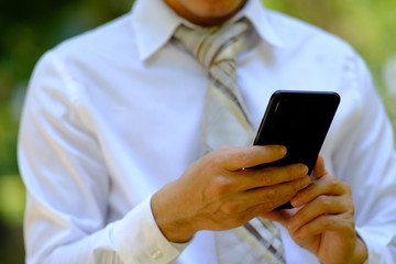 businessman using a smartphone and space for text