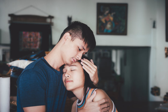 Young Couple Hugging Each Other Tightly, Man Comforting His Sad Mourning Girlfriend Embracing Her In The Room.