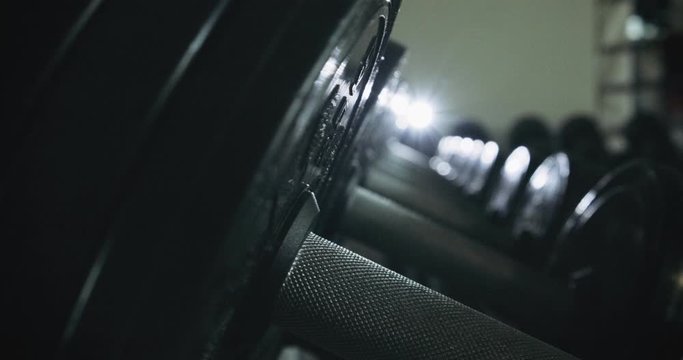 Dumbbells row in modern sport club gym. Close up of sport equipment