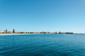 Fototapeta premium Rockingham Beach on a sunny day with clear blue sky and blue water