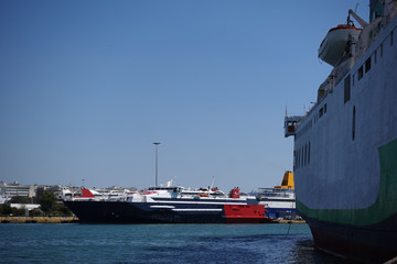 Photo of anchored passenger ferries in busy port of Piraeus on a spring morning, Attica, Greece