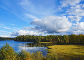 Beautiful landscape with a quiet forest lake in the time of Golden autumn. Russia, East Karelia