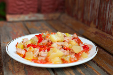 Plate of  stew zucchini and sausages.