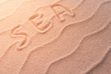 RELAX lettering on sand with wave and evening light. Minimal exotic vacation and travel concept, Flat lay top view copy space