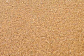 Fototapeta na wymiar Textured wet sand beach background