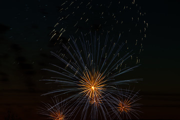 Bright colored fireworks on a festive night. Explosions of colored fire in the sky.