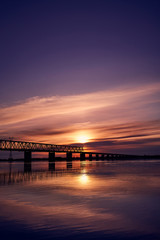 Fototapeta na wymiar Sunset over bridge through Zeya river