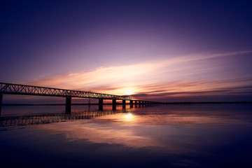 Sunset over bridge through Zeya river