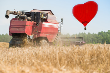 combine harvester on a wheat field with blue sky