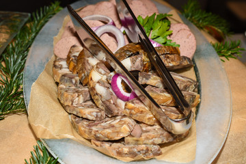 Romanian traditional Christmas food buffet with sorici, caltabos, toba and pork meat cuts, ham