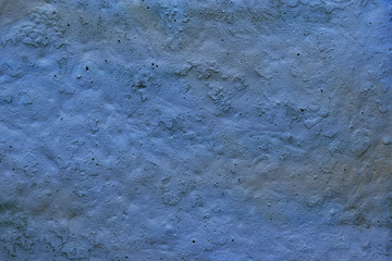 old rough surface of a concrete wall with an uneven coating