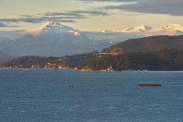 English Bay and Mt Tantalus. English Bay with historic Point Atkinson Lighthouse and the Tantalus mountain range in the background. Vancouver, British Columbia, Canada.

